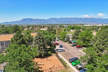 A parking lot with cars and a mountain range in the background